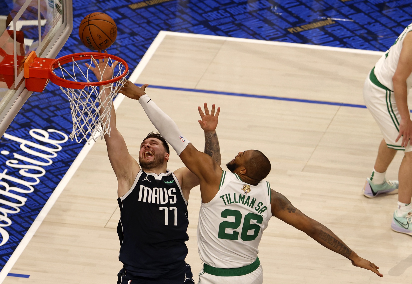 Former Michigan State star Xavier Tillman defends a layup by Luka Doncic.