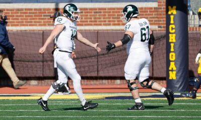 Michigan State football players Rocky Lombardi and JD Duplain slap hands during the Michigan game in 2020.