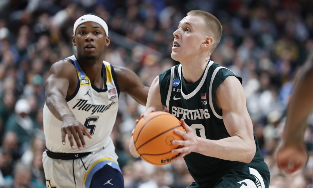 Michigan State basketball star Joey Hauser goes up for a shot against Marquette.
