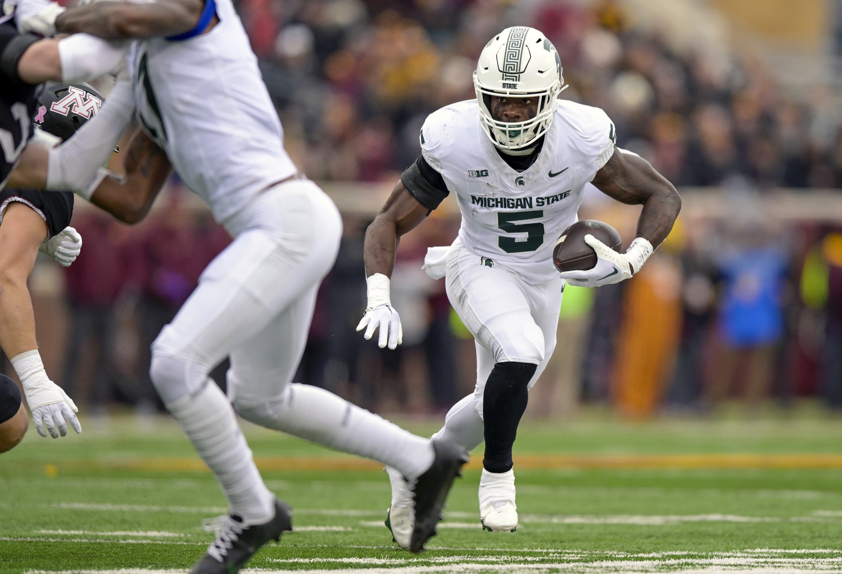 Michigan State football running back Nathan Carter runs against Minnesota.