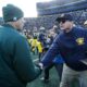 Jim Harbaugh shakes Michigan State football coach Mark Dantonio's hand.