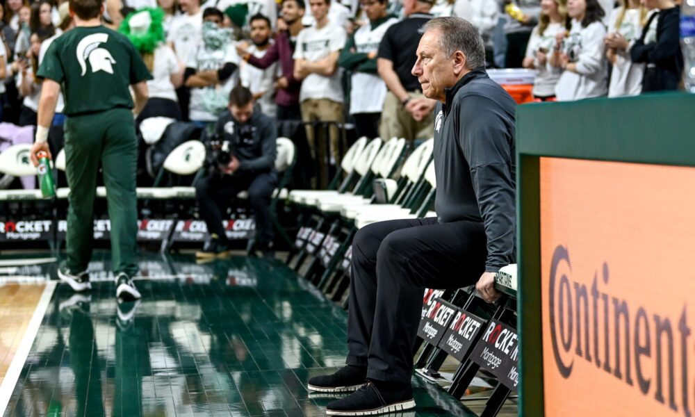 Michigan State basketball coach Tom Izzo sits on the bench before the game.