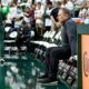 Michigan State basketball coach Tom Izzo sits on the bench before the game.