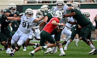 Michigan State football defensive tackle Alex VanSumeren extends for a sack attempt in the spring game.