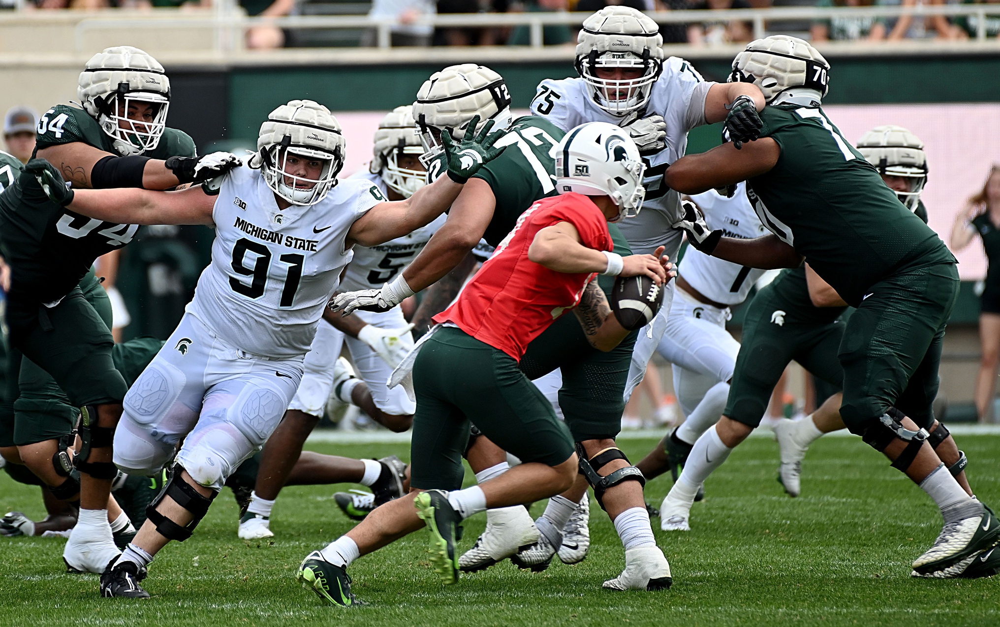 Michigan State football defensive tackle Alex VanSumeren extends for a sack attempt in the spring game.