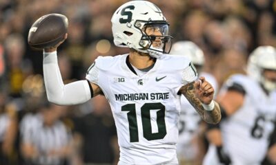 Former Michigan State football QB1 Noah Kim steps back to pass vs. Iowa.