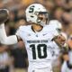 Former Michigan State football QB1 Noah Kim steps back to pass vs. Iowa.