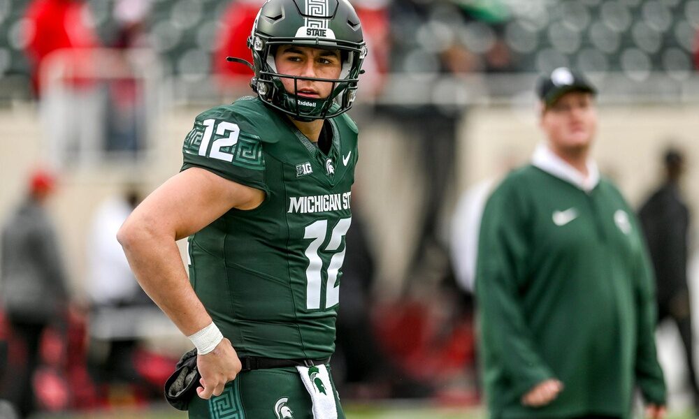 Former Michigan State football quarterback Katin Houser warms up before a game.