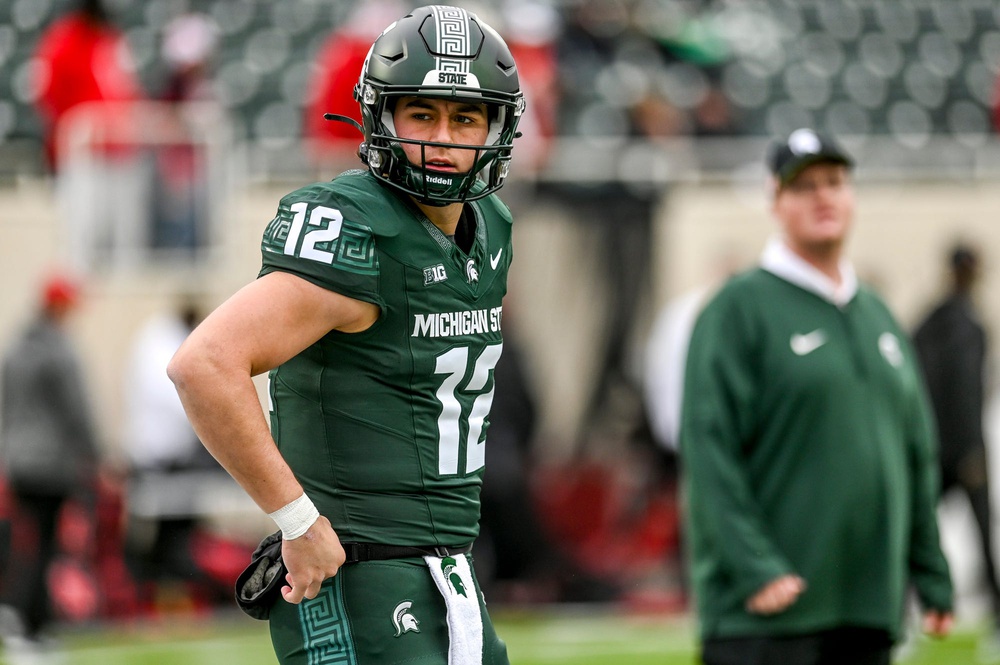 Former Michigan State football quarterback Katin Houser warms up before a game.