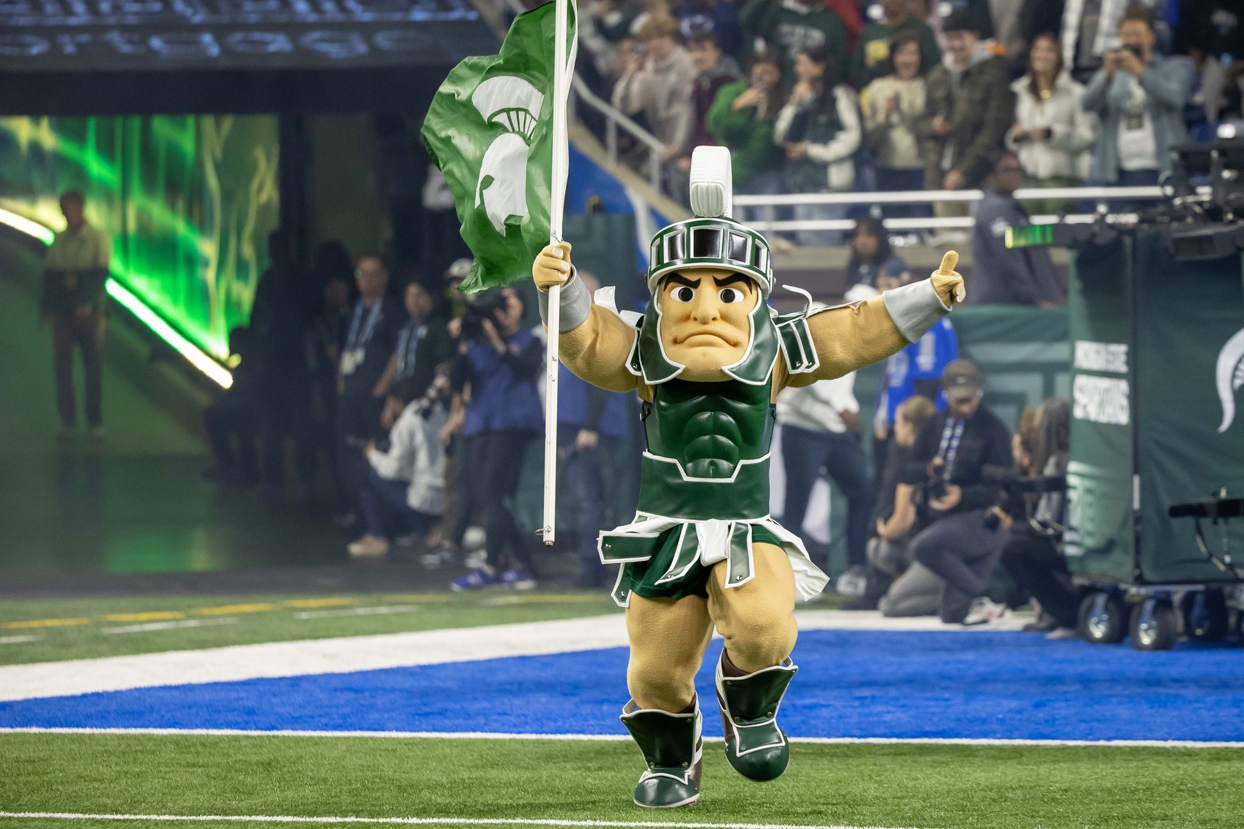 Michigan State football mascot Sparty runs out onto Ford Field.