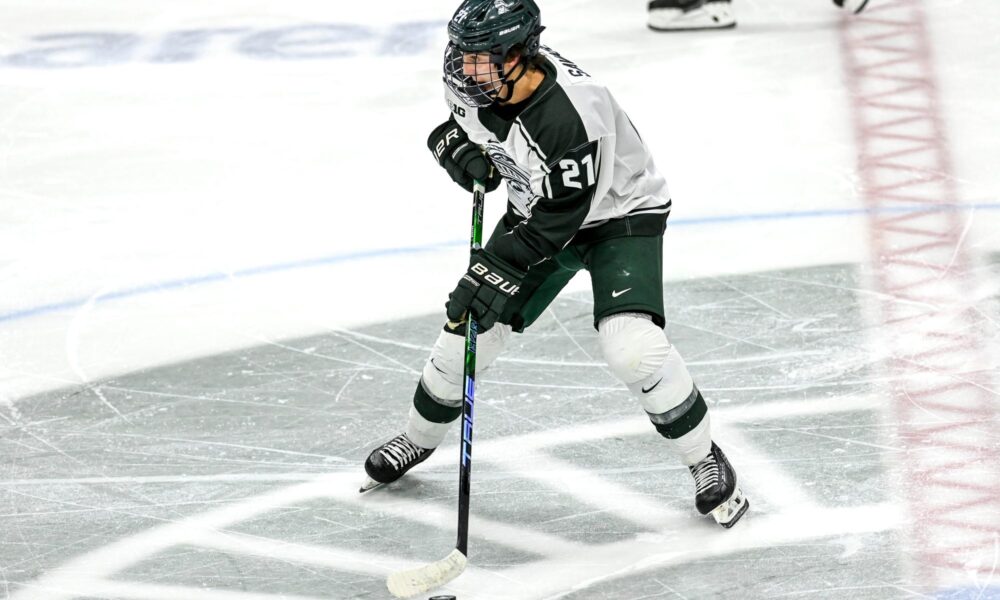 Michigan State hockey star Red Savage skates up the ice.