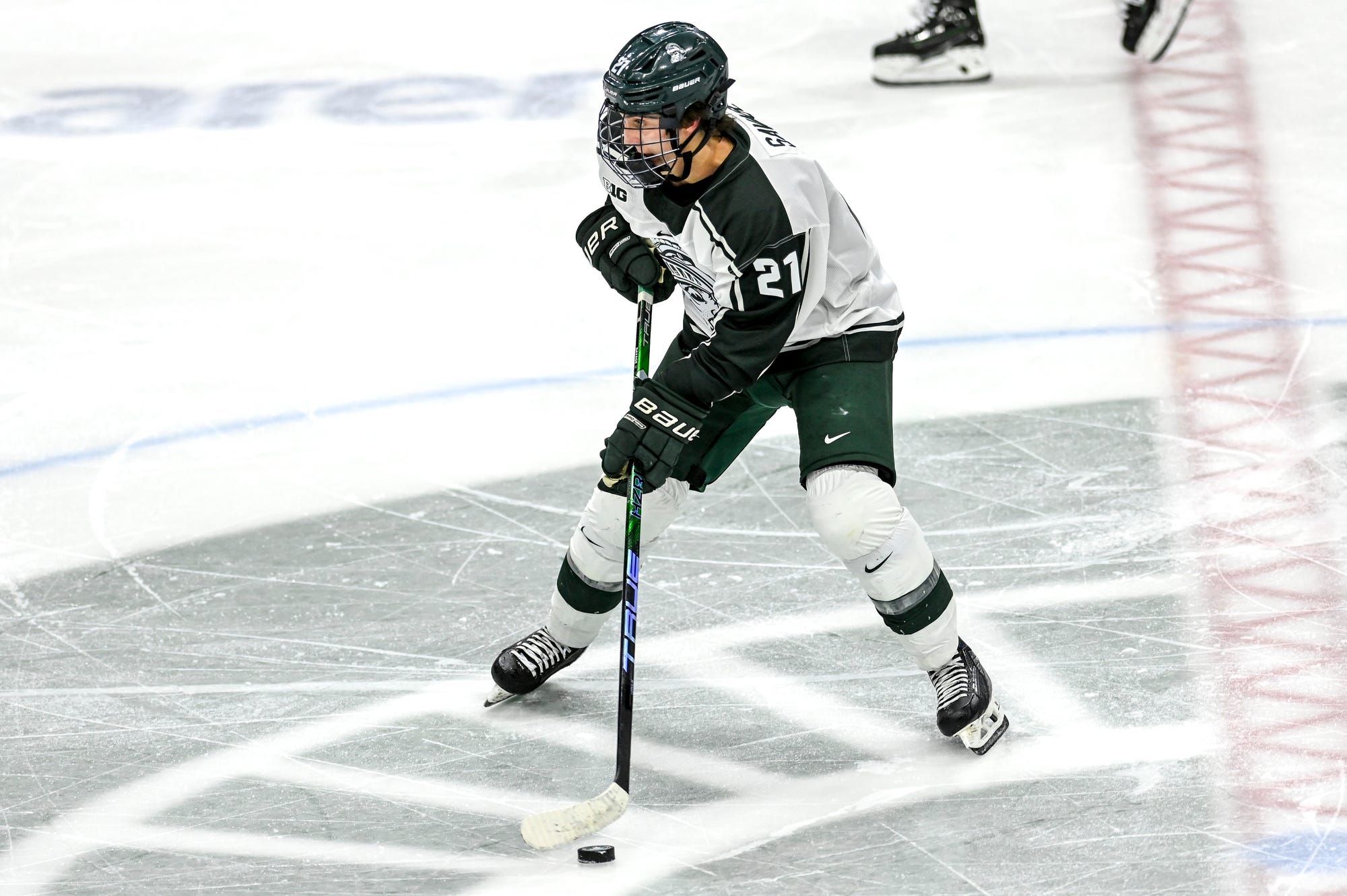 Michigan State hockey star Red Savage skates up the ice.