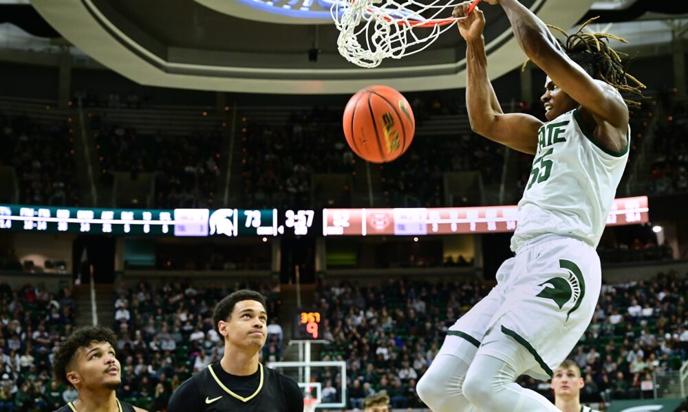 Michigan State basketball star Coen Carr dunks the ball against Oakland.