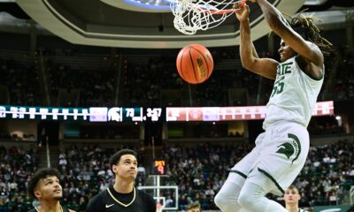 Michigan State basketball star Coen Carr dunks the ball against Oakland.