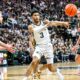 Michigan State basketball star Jaden Akins passes the ball vs. Iowa