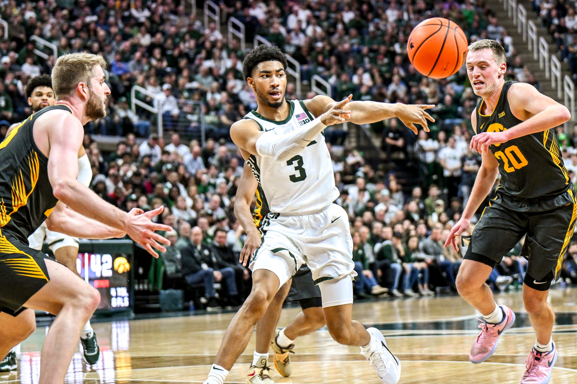 Michigan State basketball star Jaden Akins passes the ball vs. Iowa