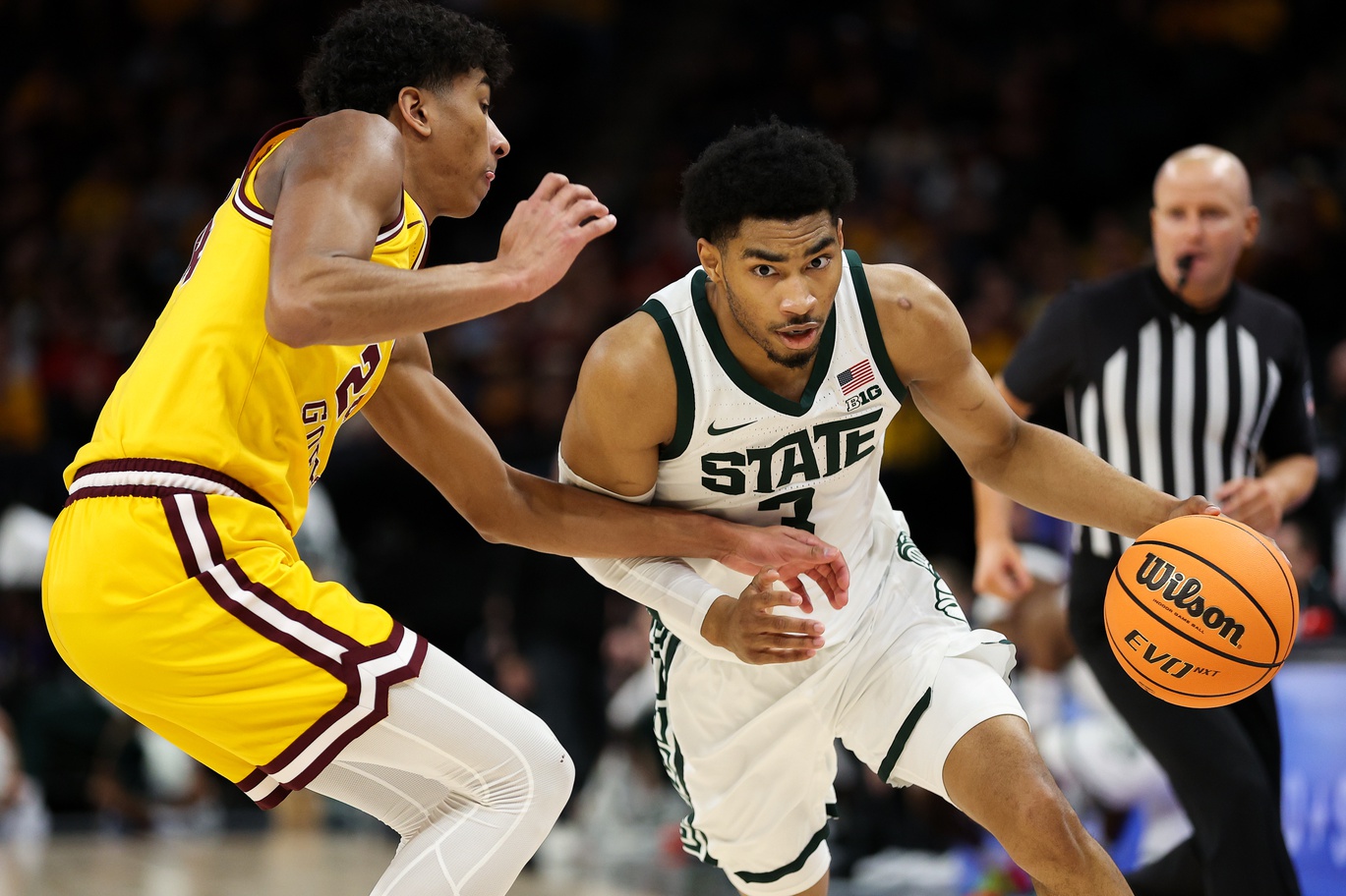 Michigan State basketball star Jaden Akins dribbles the ball against Minnesota.