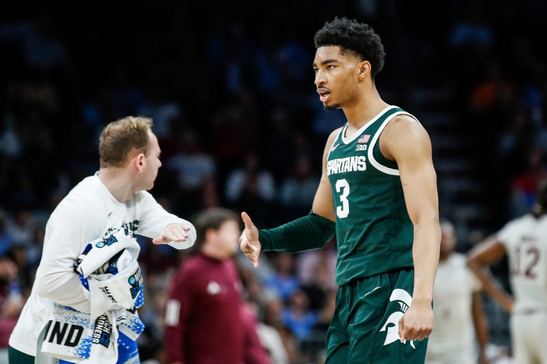 Michigan State basketball star Jaden Akins celebrates a basket.