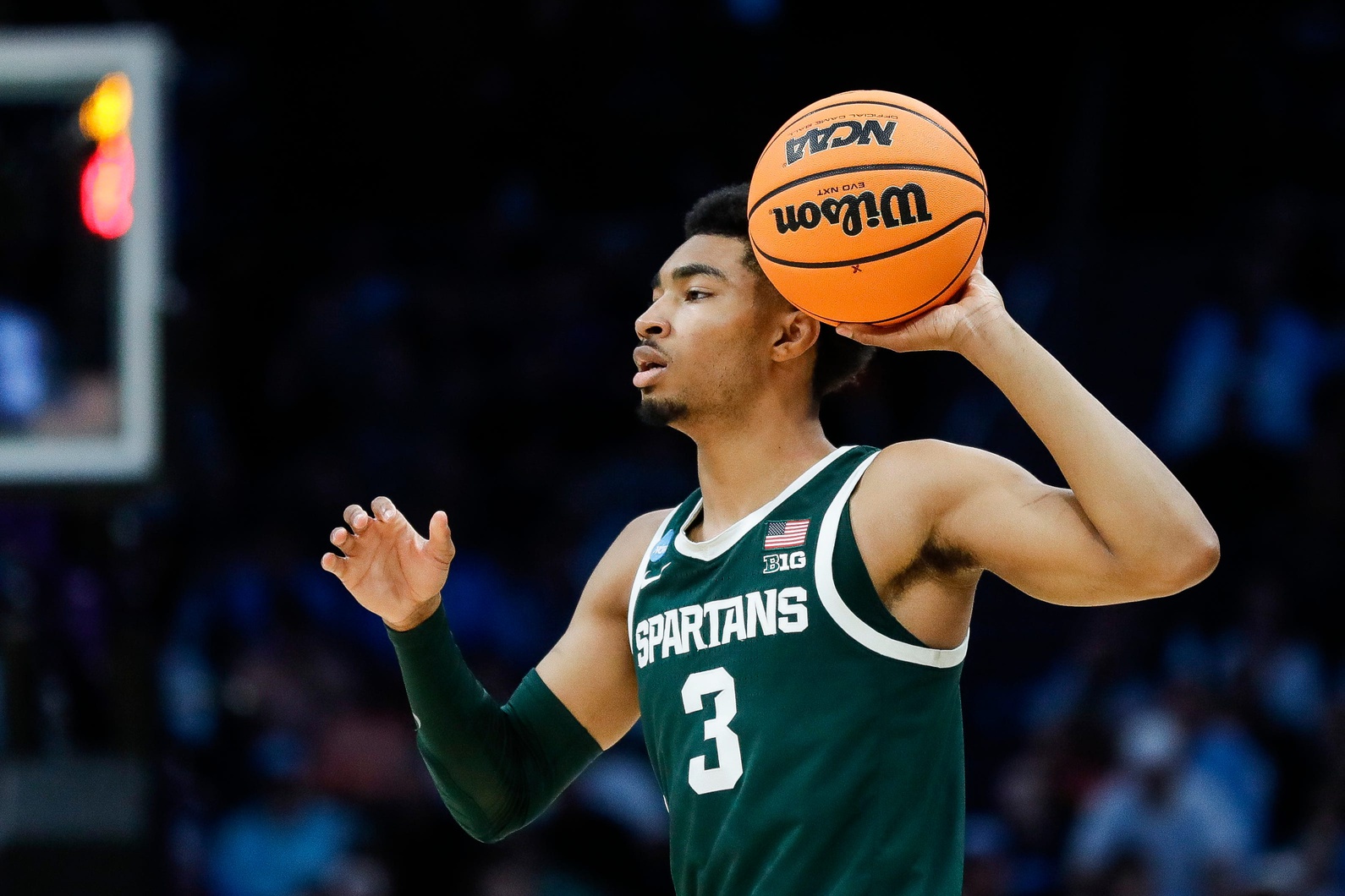 Michigan State basketball guard Jaden Akins looks to pass.