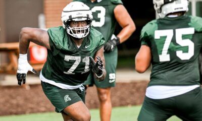 Michigan State football lineman Kristian Phillips runs a drill during fall camp.