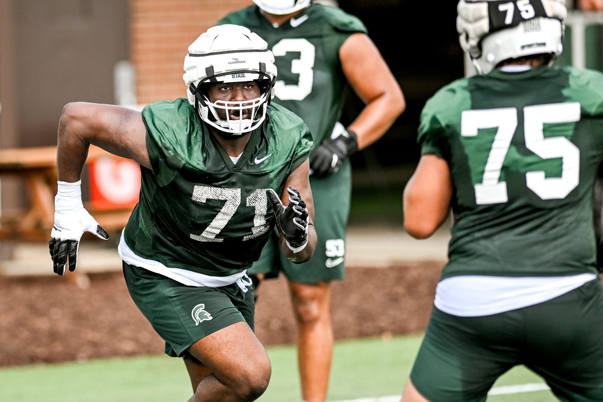 Michigan State football lineman Kristian Phillips runs a drill during fall camp.