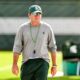 Michigan State football coach Jonathan Smith walks around during fall camp warmups.