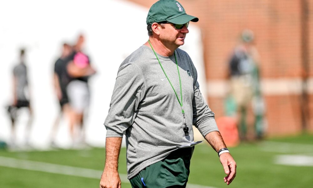 Michigan State football coach Jonathan Smith walks around during fall camp.