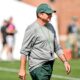 Michigan State football coach Jonathan Smith walks around during fall camp.