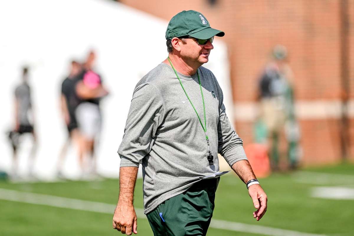 Michigan State football coach Jonathan Smith walks around during fall camp.