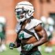 Michigan State football linebacker Jordan Turner warms up during fall camp.