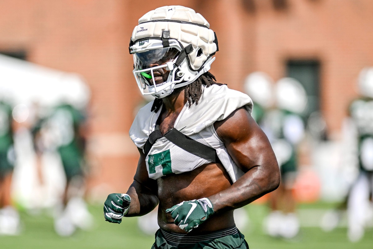 Michigan State football linebacker Jordan Turner warms up during fall camp.