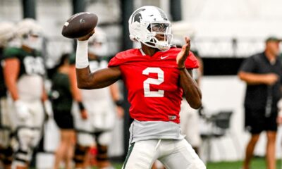 Michigan State football quarterback Aidan Chiles warms up during fall camp.