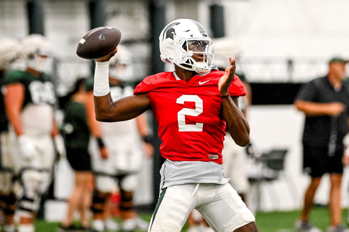 Michigan State football quarterback Aidan Chiles warms up during fall camp.