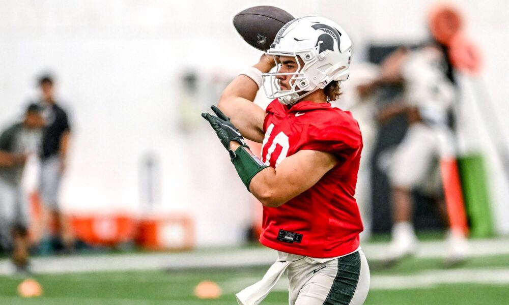 Michigan State football backup Tommy Schuster warms up.