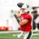 Michigan State football backup Tommy Schuster warms up.