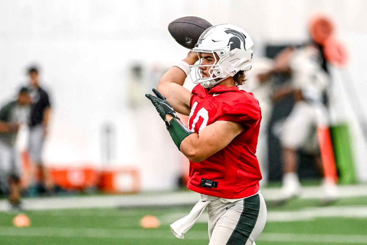 Michigan State football backup Tommy Schuster warms up.