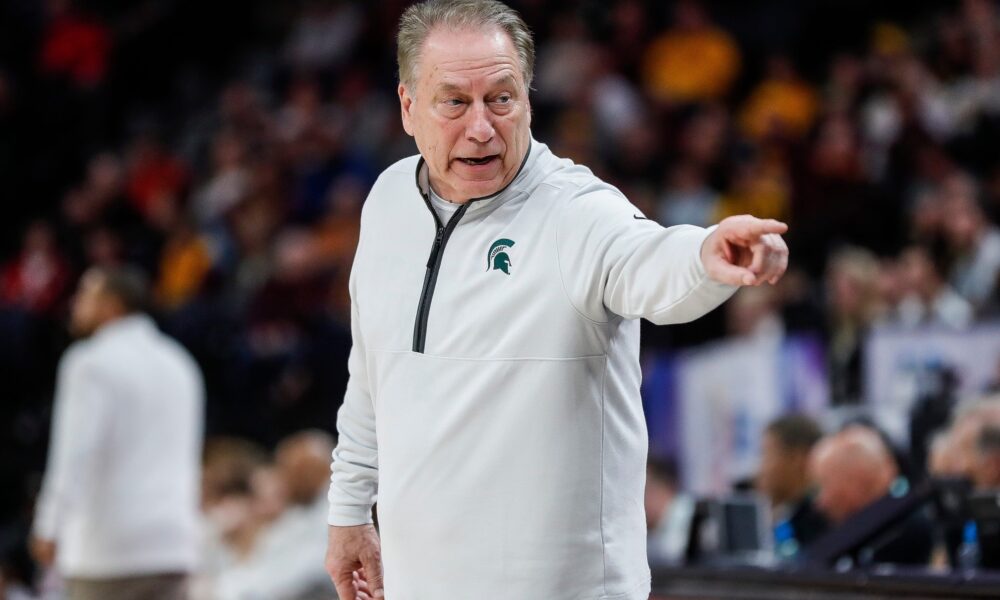 Michigan State basketball coach Tom Izzo points toward his bench.