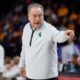 Michigan State basketball coach Tom Izzo points toward his bench.