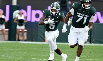 Michigan State football lineman Kristian Phillips blocks for Nate Carter.