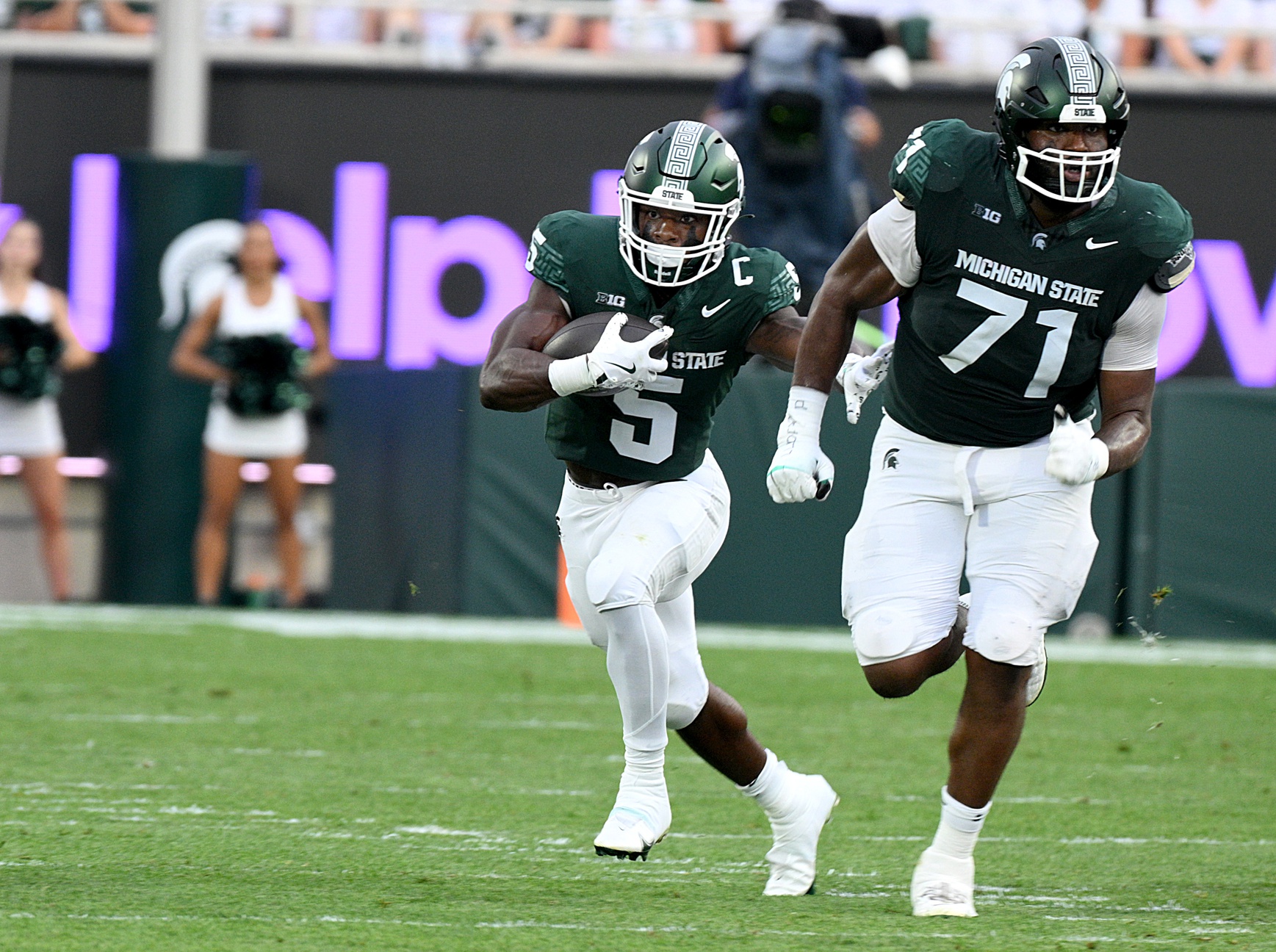 Michigan State football lineman Kristian Phillips blocks for Nate Carter.