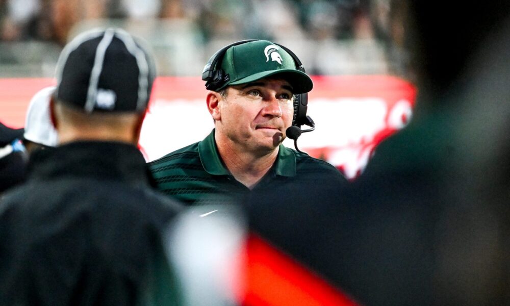 Michigan State football coach Jonathan Smith looks on.