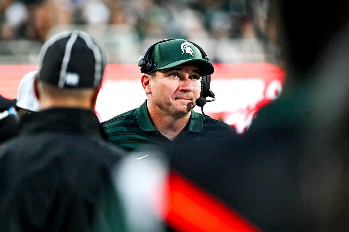 Michigan State football coach Jonathan Smith looks on.