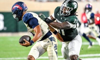 Michigan State football defender Ken Talley makes a sack.