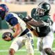 Michigan State football defender Ken Talley makes a sack.