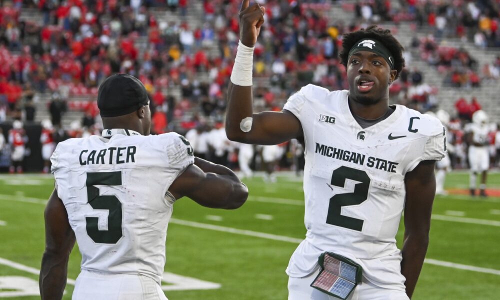 Michigan State football quarterback Aidan Chiles and running back Nate Carter celebrate a win.