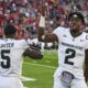 Michigan State football quarterback Aidan Chiles and running back Nate Carter celebrate a win.