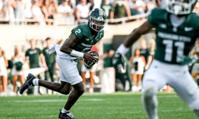 Michigan State football quarterback Aidan Chiles rolls out to pass.