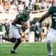 Michigan State football quarterback Aidan Chiles rolls out to pass.