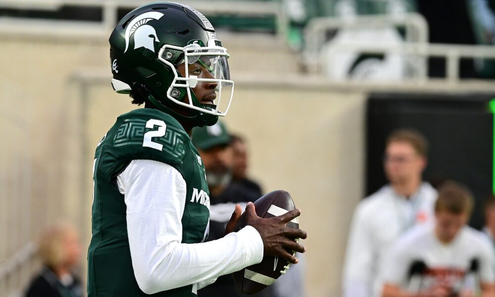 Michigan State football quarterback Aidan Chiles warms up