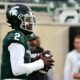 Michigan State football quarterback Aidan Chiles warms up